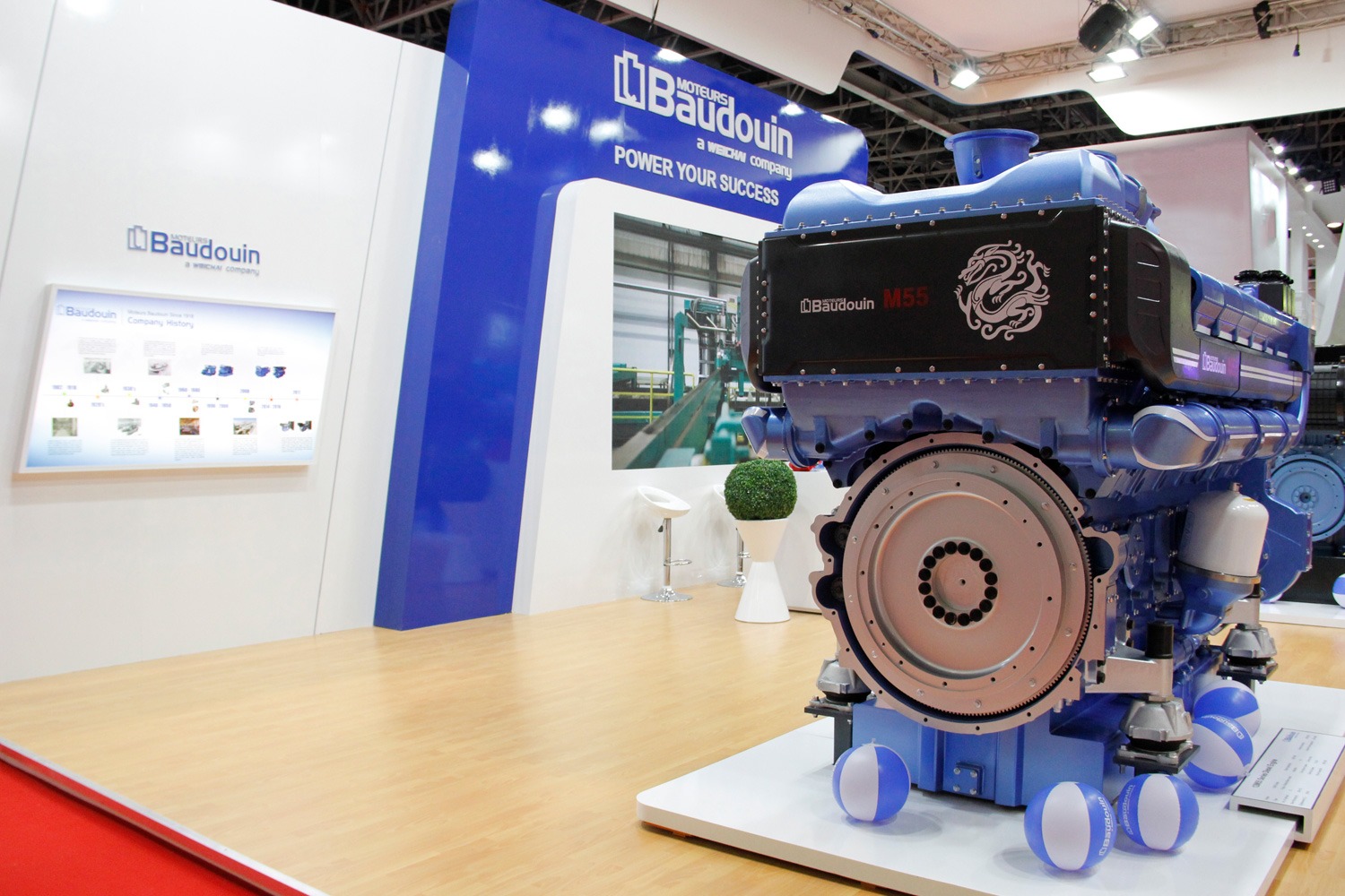 A Moteurs Baudouin M55 engine on a blue exhibition stand at Middle East Energy 2022.